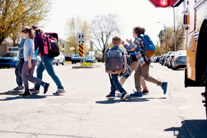 Photograph of kids crossing a road