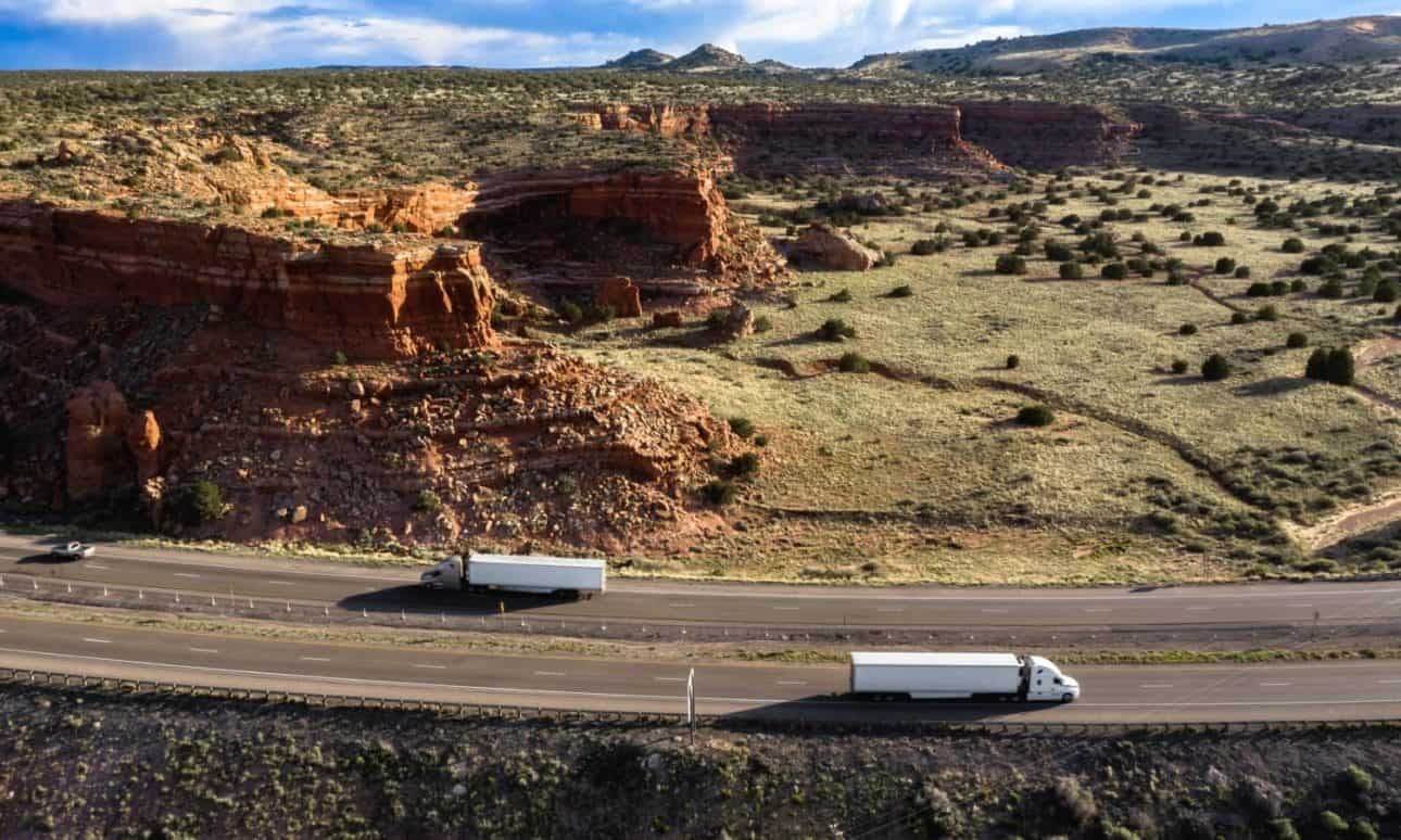 Aerial shot of trucks on desert highway