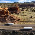 Aerial shot of trucks on desert highway